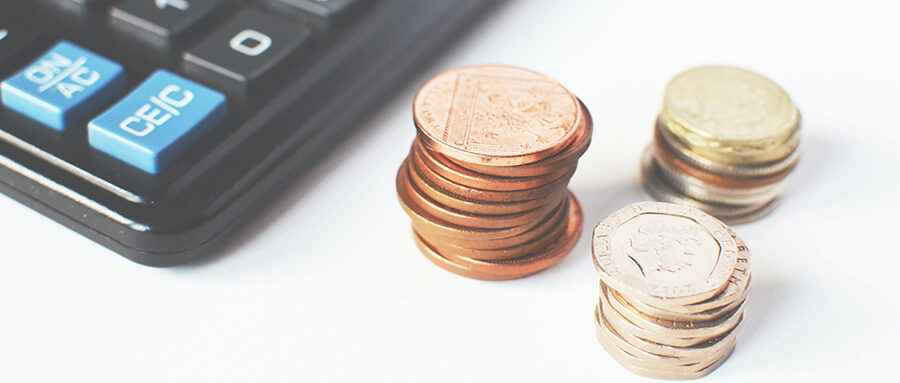 A calculator and some sterling coins