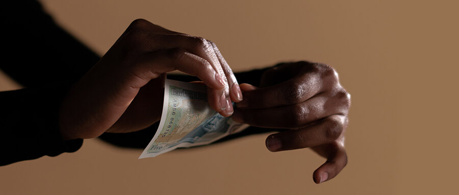 Hands Ripping Pound Note