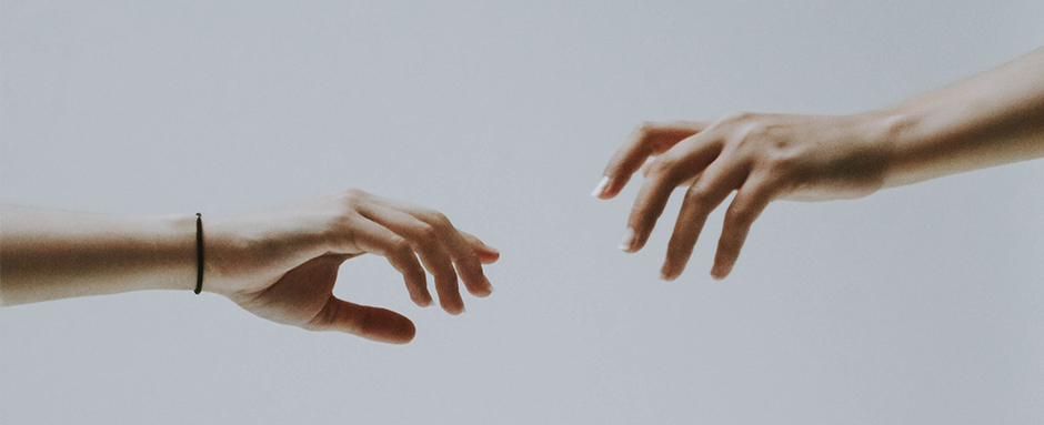 Two hands reaching for each other