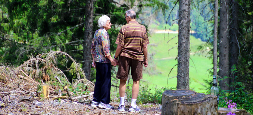 Retired couple walking through woods