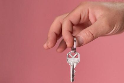 Hand holding house key