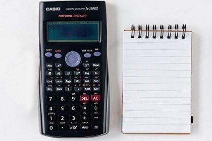 A calculator with pen and paper